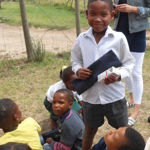 A leaner proudly holding his new stationery bag