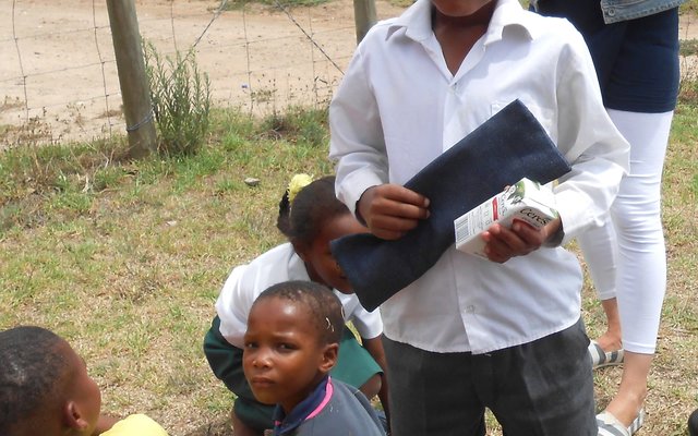 A leaner proudly holding his new stationery bag