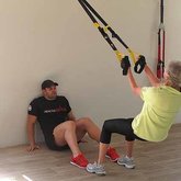 TRX time , Pieta helps keep his client keep proper form