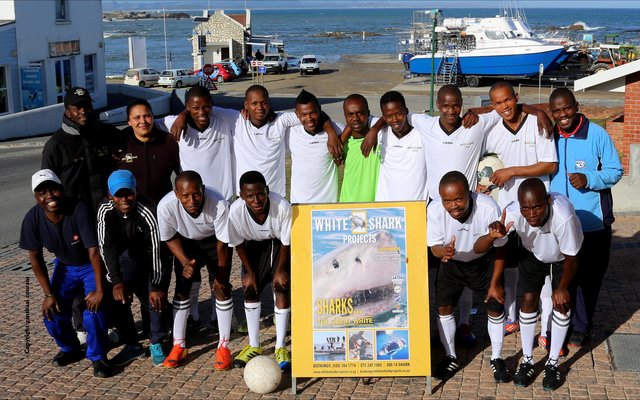 Masakaneâ€™s Eastern Cape United soccer team played in the local league for the past two seasons.  In the first season, the team finished 14th out of 17 teams and in the second season bettered itself to a number seven position. They were privileged to receive brand new outfits from White Shark Projects (WSP) previously.  Natasha Smith from WSP appears here with Mandlonke Ngazini (middle) who initiated the sponsorship and who is working at WSP for the past thirteen years.  Mr Ngazini said that the main objects are to keep the youth off the streets and to fight against drug abuse through healthy sport participation.  He thanked White Shark Projects for the generous sponsorship.  Anyone interested in participating in any of Eastern Cape Unitedâ€™s team efforts can contact the Chairperson, Mr Mhlaba at 0735771207.