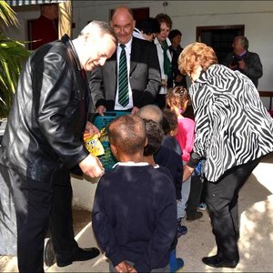 AVBOB Group CEO, Frik Rademan (left) and Overstrand Executive Mayor, Nicolette Botha-Guthrie (right) pictured handing out goody bags to learners of The Fynbos Academy, while AVBOBâ€™s Western Cape Provincial Manager, Johan Tinderholem lends assistance.
