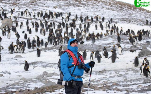 Wilfred Chivell, the â€œice-manâ€ during his and Susan Visagieâ€™s visit to the Salisbury Plain in South Georgia, with thousands of King penguins behind him.
