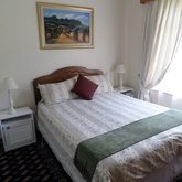 Unit 1: main bedroom with garden and mountain views