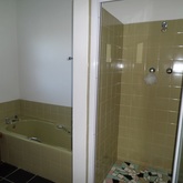 Unit 1: Bathroom with tub and shower. Separate toilet
