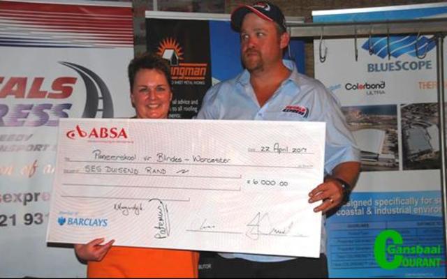 Die eerste R6 000 vir die Pionierskool vir Blindes in Worcester,  wat  intussen na R25 000 opgeskuif het, word deur Colleen de Kock  aan Edwan Swart van Petals Express oorhandig. 