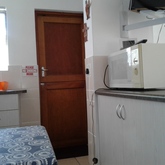 Unit 2: kitchen with door to patio with braai facilities.