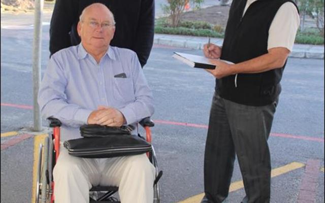 Deputy Mayor Dudley Coetzee has taken up the Wheelchair Wednesday challenge to walk in the shoes (so to speak!) of a wheelchair user. With him are (right) Don Kearney, area manager of the Hermanus Administration and Gerhard Smit, manager of social development.