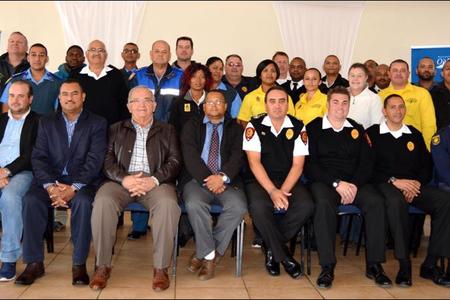 The Overstrand Fire Department recently hosted an end of fire season debriefing session at the Pringle Bay Community Hall. Front fltr Overstrandâ€™s Cllr Fanie Krige (Kleinmond), Cllr Grant Cohen (Kleinmond), Neville Michaels (Director:  Protection Services), Coenie Groenewald (Municipal Manager), Cllr Arnie Africa (Portfolio Head:  Protection Services), Lester Smith (Chief:  Fire, Rescue and Disaster Management), Marlu Rust (Snr Disaster Management Officer) and Angelo Aplon (Ass Chief:  Fire, Rescue and Disaster Management). The large group at the back included officials of the Overstrand Traffic, Fire and Law Enforcement, Overberg District Municipality, Greater Overberg Fire Protection Association, City of Cape Town Fire and Rescue, CapeNature, NCC Environmental Services and Provincial Traffic.