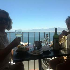 Happy guests enjoying a meal and the view.