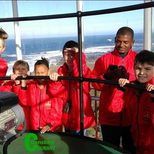 An  excited  group  of Paul Greyling Primary Schoolâ€™s learners in the top part of Dangerpoint Lighthouse.