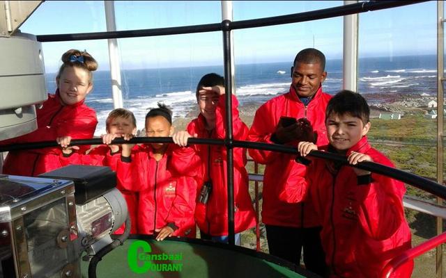 An  excited  group  of Paul Greyling Primary Schoolâ€™s learners in the top part of Dangerpoint Lighthouse.