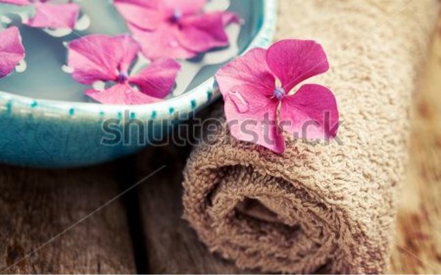 stock_photo_bottle_of_essential_oil_bowl_with_flowers_and_towel_spa_concept_219206665_1500643650