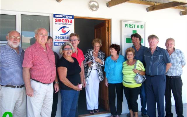 Sandra Prinsloo het â€˜n aktiewe rol gespeel wat in 2013 tot die amptelike opening van die Pearly Beach Noodhulp-kamer aanleiding gegee het. Hierdie foto is destyds deur die Gansbaai Courant geneem:  voor van links is Theo Coetzer, rdl Dudley Coetzee, Ilse Keet, Suster Tertia Scholtz, Sandra Prinsloo, rdl Nicolette Botha-Guthrie (voormalige Overstrandse Uitvoerende Burgemeester), Marleen Haddon, Elize van Eeden, Hakkie HÃ¼ckstedt, rdl Pieter Scholtz en Daan FouchÃ¨.