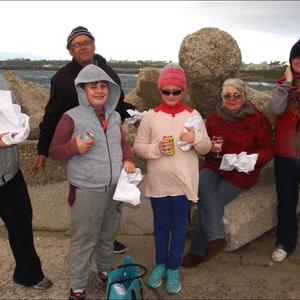 Hierdie twee gesinne met hulle vis & skyfies sÃª dit was die moeite werd om die reÃ«n te trotseer tydens Gansbaai Toerisme se â€œSunset Walkâ€. Voor van links is Luke Devitt, Emily Kellerman, Anmarie Watney en Justina Kellerman. Agter is Carol en Wayne Devitt.