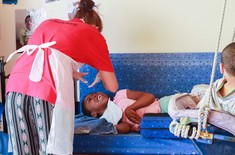 Elim_home_volunteer_interacting_with_girl_1518417940