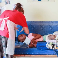 Volunteer playing with girl