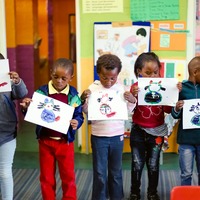 Children showing their paintings