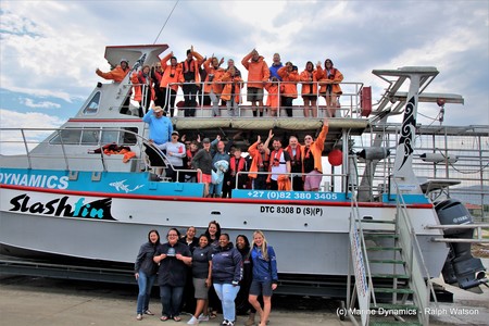 Marine Dynamics Team celebrating with clients