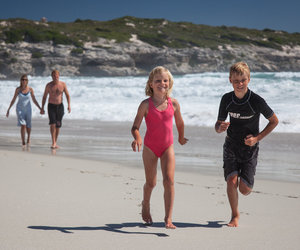 Family and kinds running on the beach