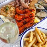 Xplorioâ„¢ Struisbaai - Catch Cook Restaurant - Seafood Platter (4 king prawns served with mussels, calamari tubes, beer battered hake, chips and aromatic basmati rice)
